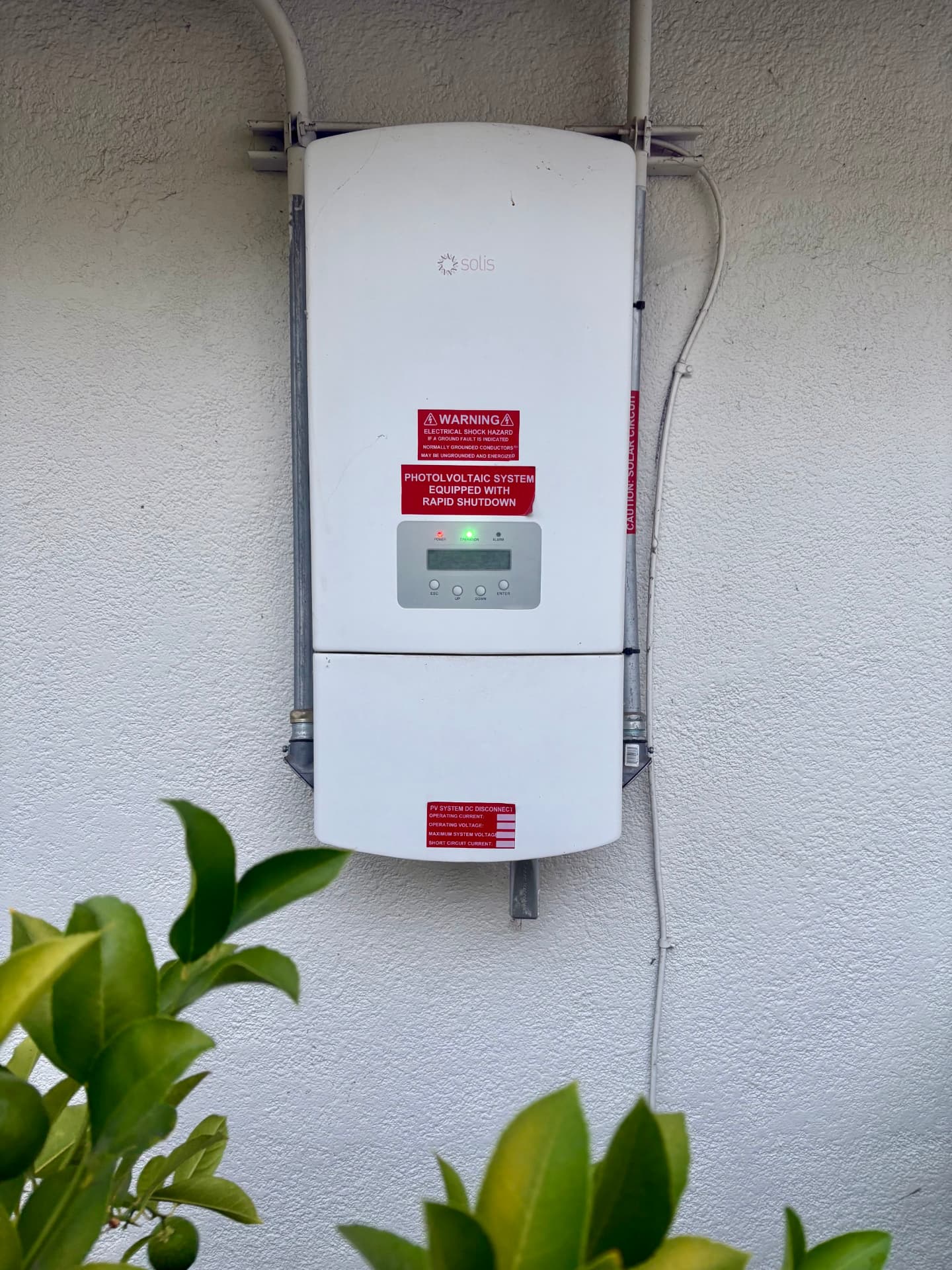 Solis grid-tied solar inverter mounted on the wall at 970 Glenwood Drive, equipped with rapid shutdown for the photovoltaic system