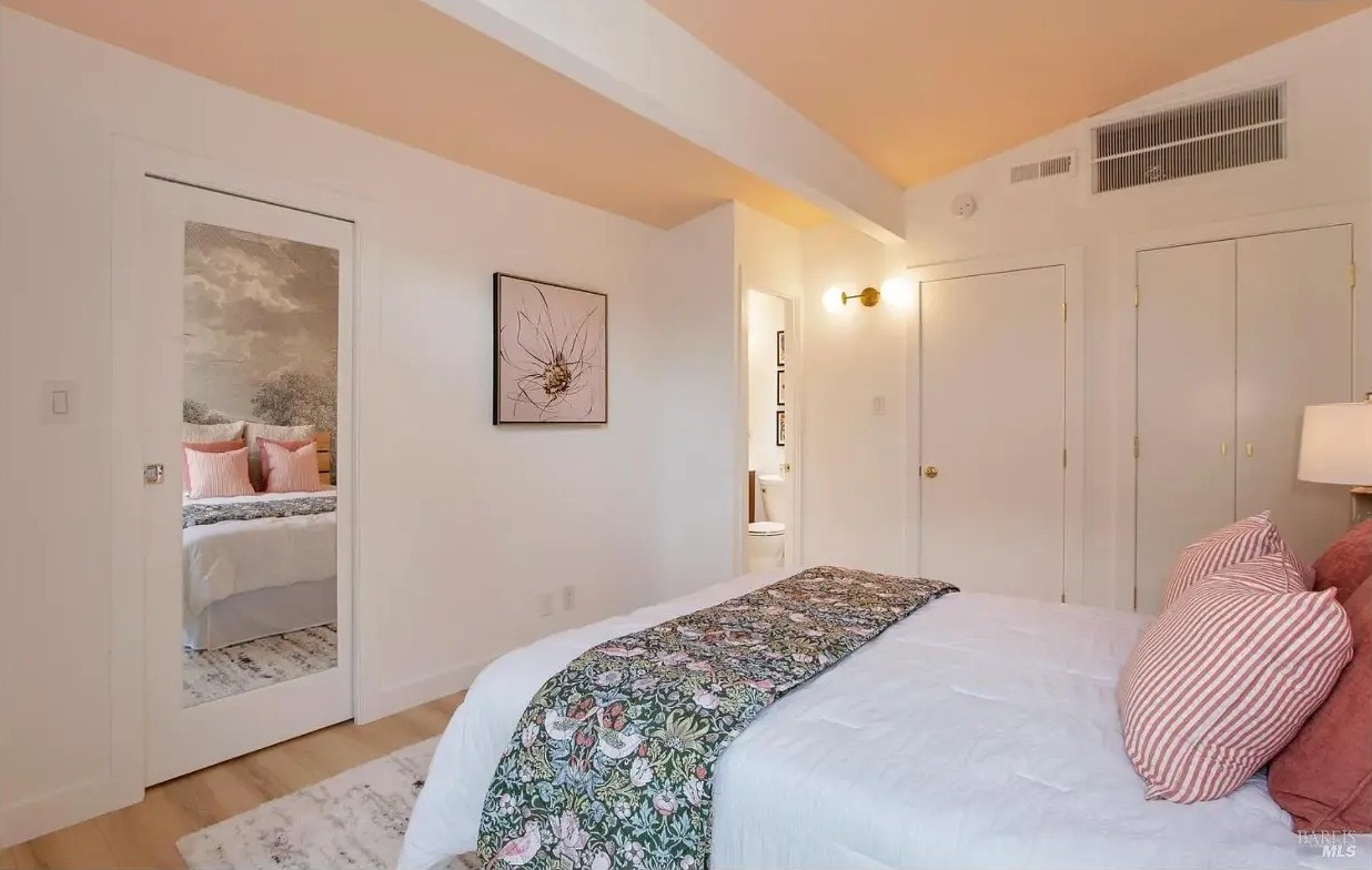Primary bedroom with dual closets and custom organizers