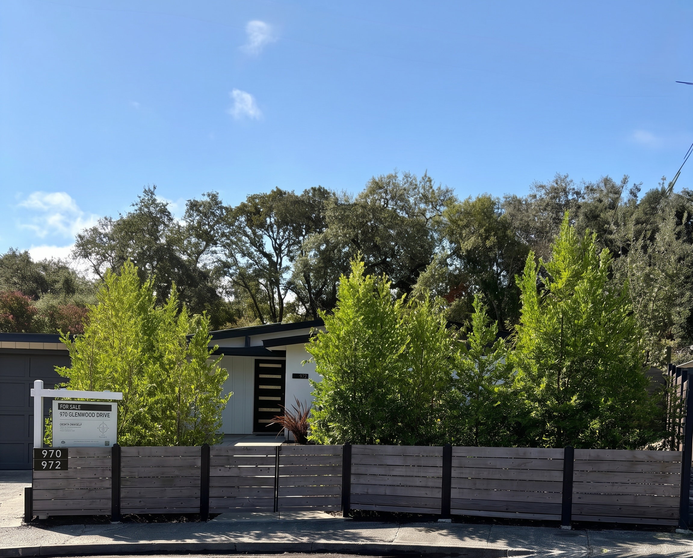 Street view of 970 and 972 Glenwood Drive behind the hedge