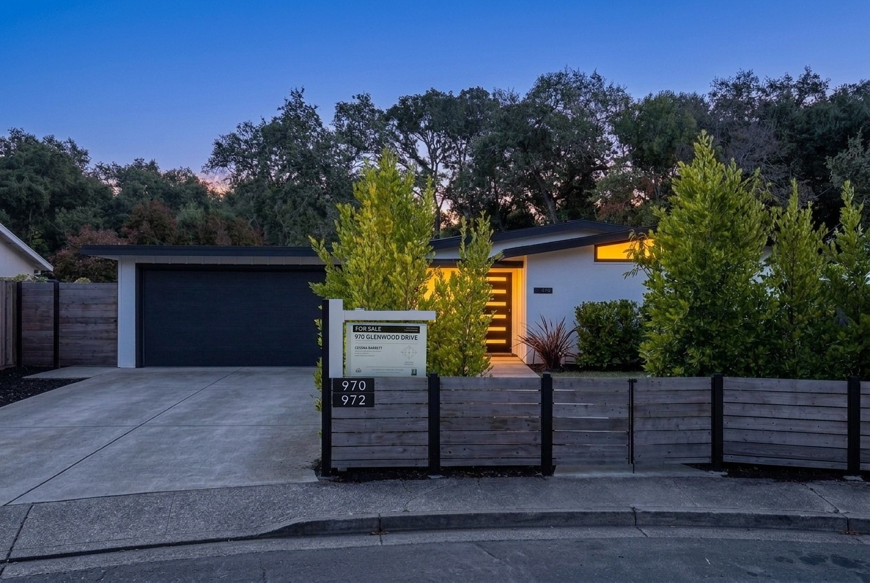 Main house exterior at twilight with a clear driveway